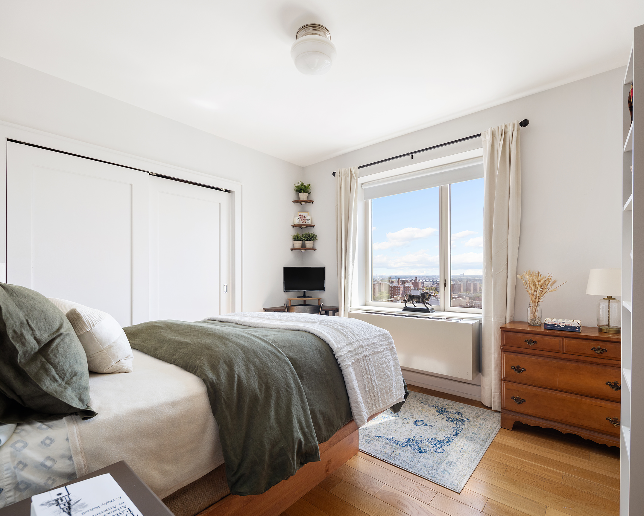 1280 5th Avenue, Unit 19E Manhattan, NY 10029 - Photo 5 of 12 a bedroom with a bed and a window