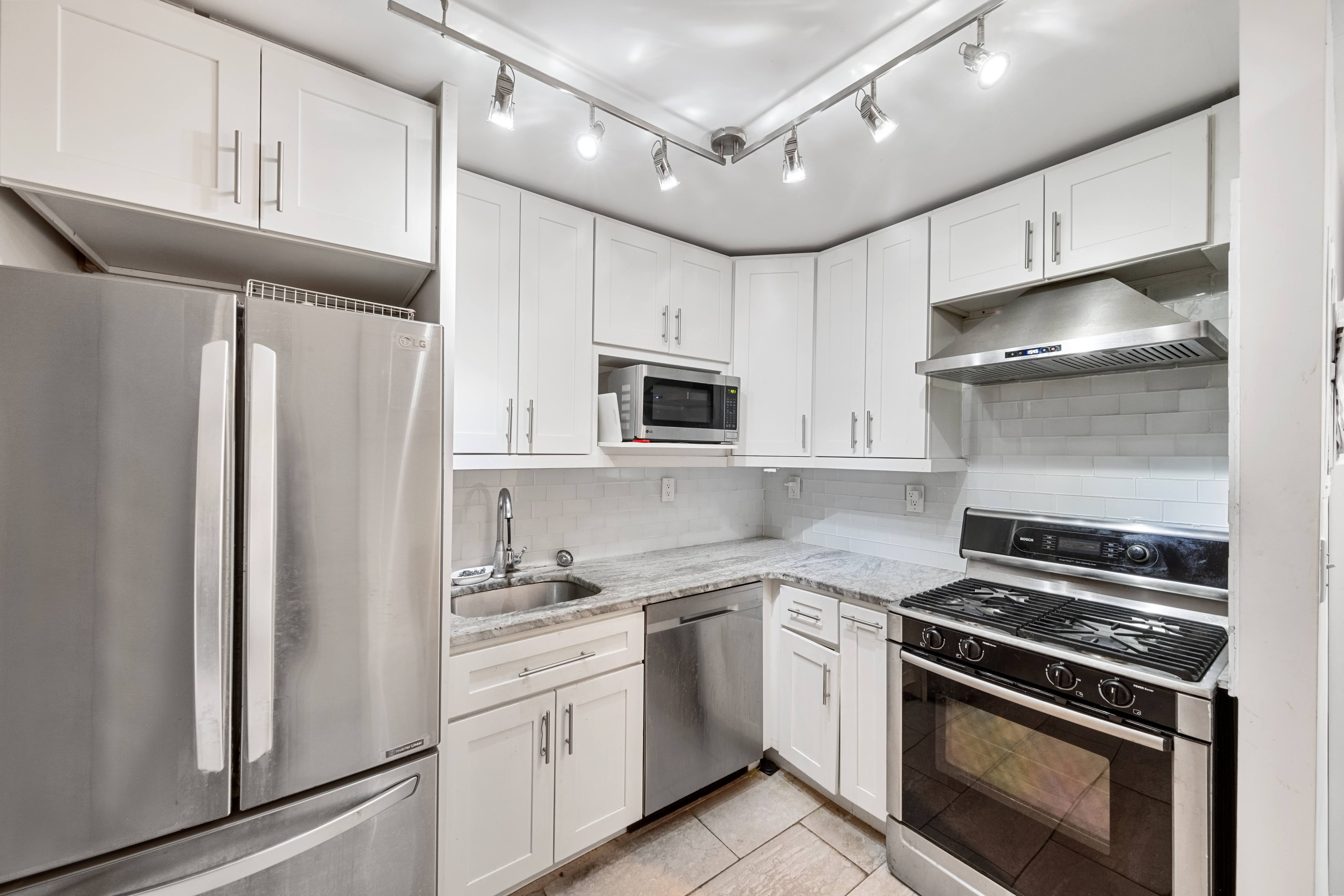 376 Broadway, Unit 4F Manhattan, NY 10013 - Photo 9 of 16 a kitchen with cabinets stainless steel appliances and a counter space