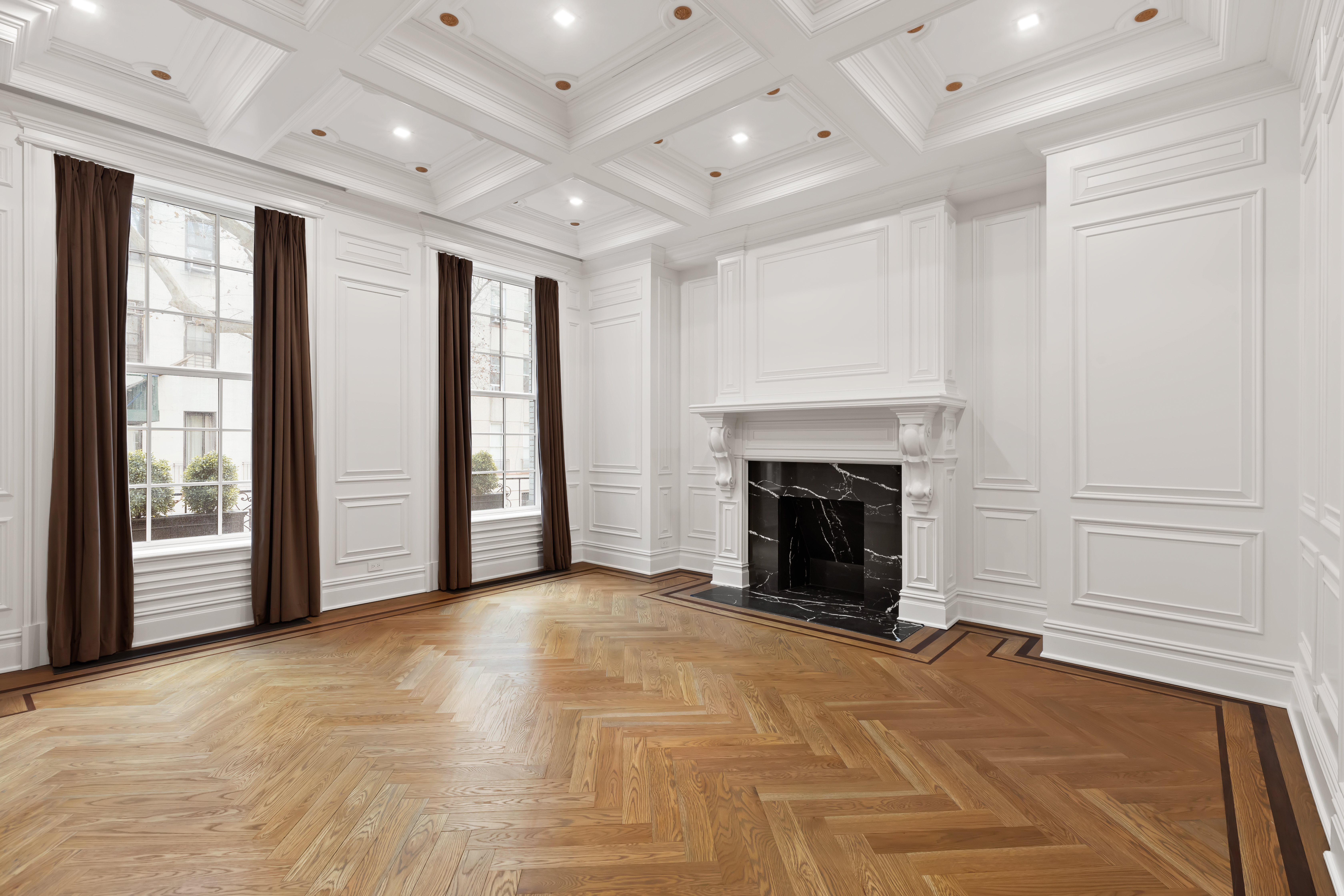127 East 64th Street, Unit 1/2 Manhattan, NY 10065 - Photo 8 of 15 a view of an empty room with a fireplace and a window
