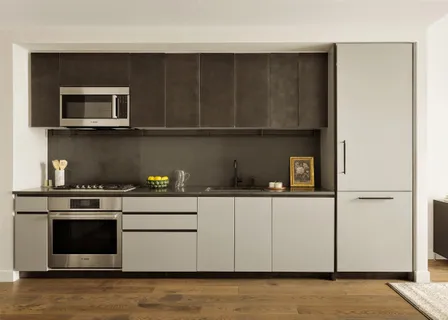 a kitchen with stainless steel appliances granite countertop a stove and a microwave
