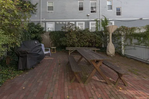 a view of backyard with seating space