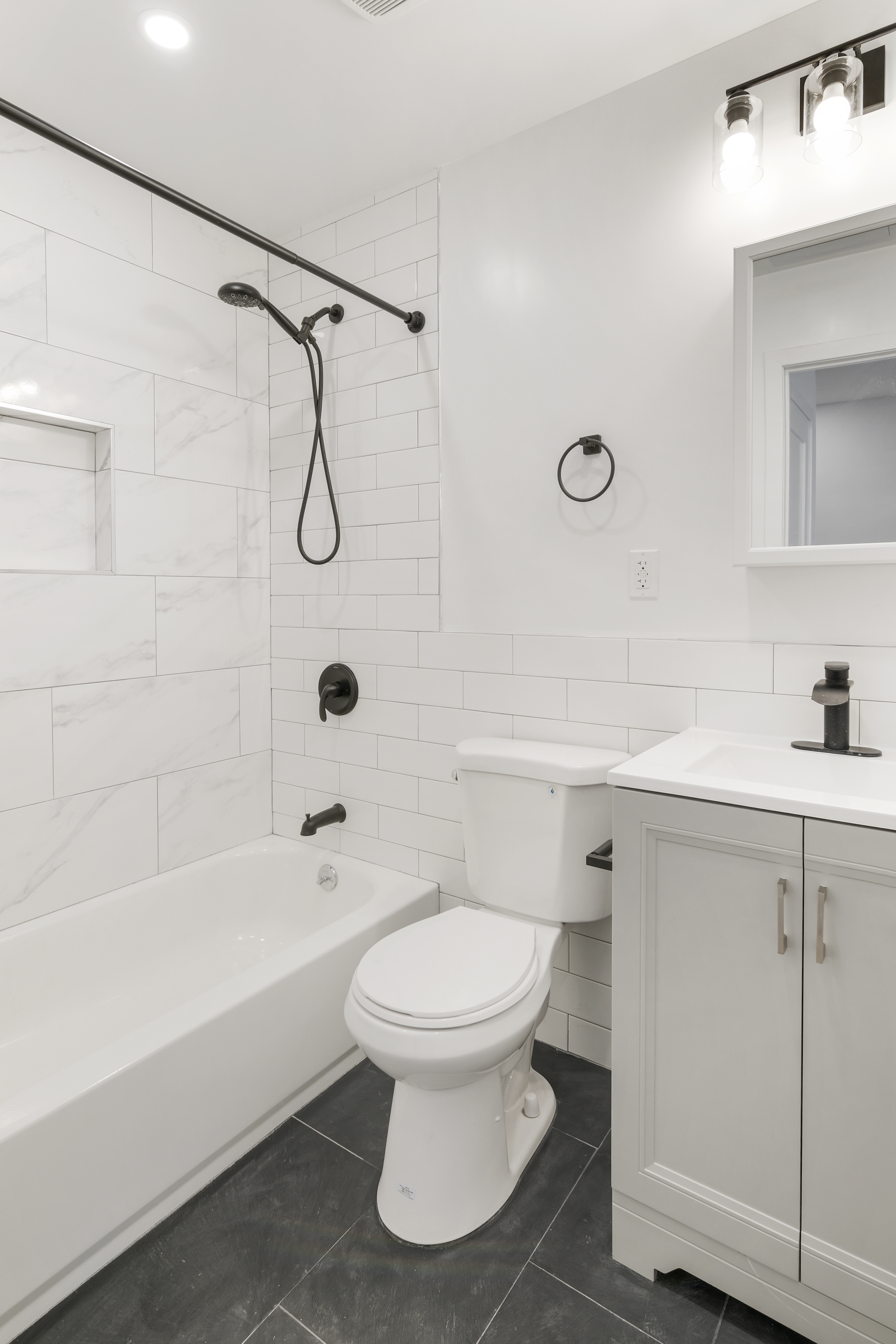366 Columbia Street, Unit 3 Brooklyn, NY 11231 - Photo 9 of 11 a bathroom with a white toilet sitting next to a bathroom sink and a shower