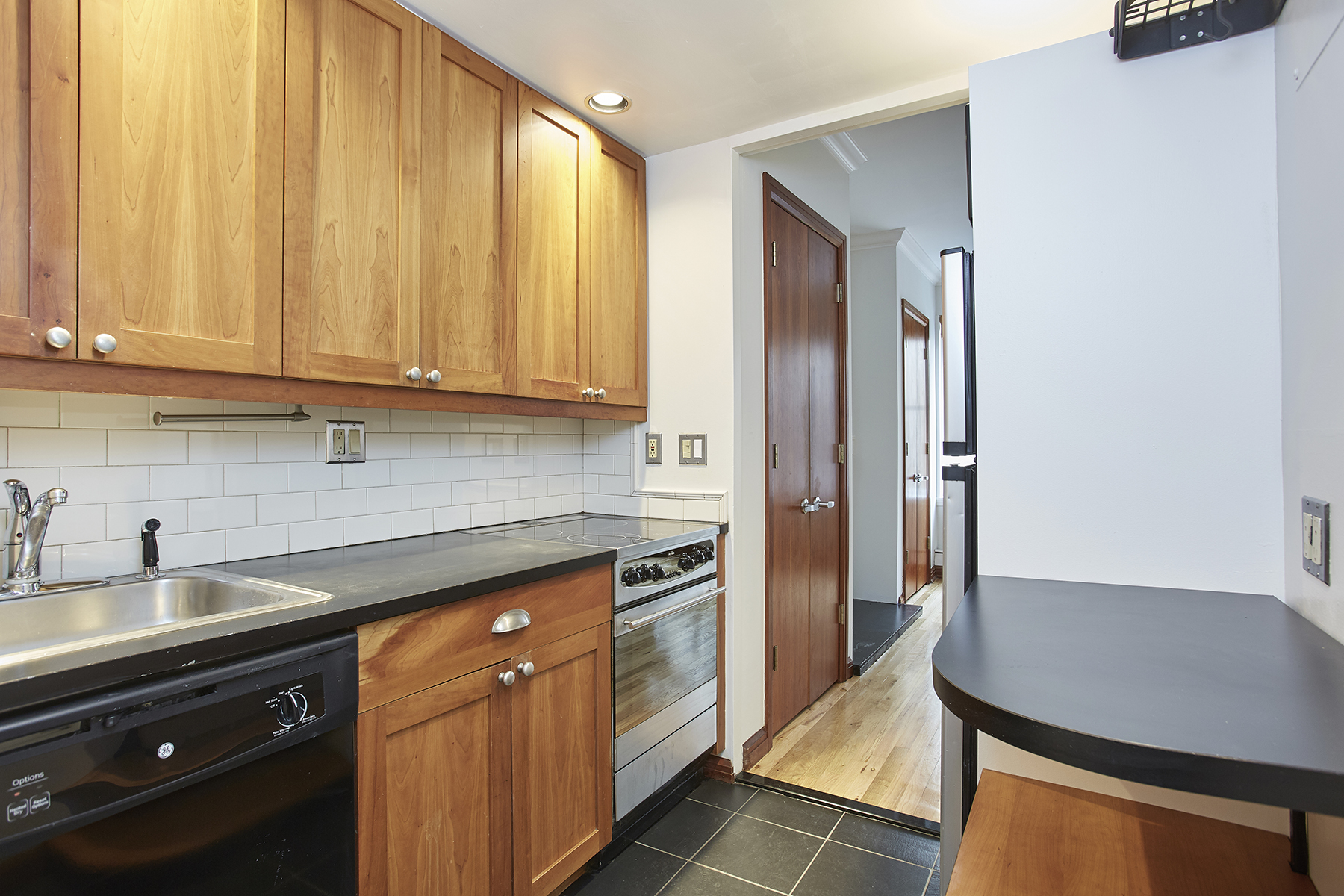 6 Bank Street, Unit 3 Manhattan, NY 10014 - Photo 2 of 6 a kitchen with stainless steel appliances granite countertop a refrigerator and a sink