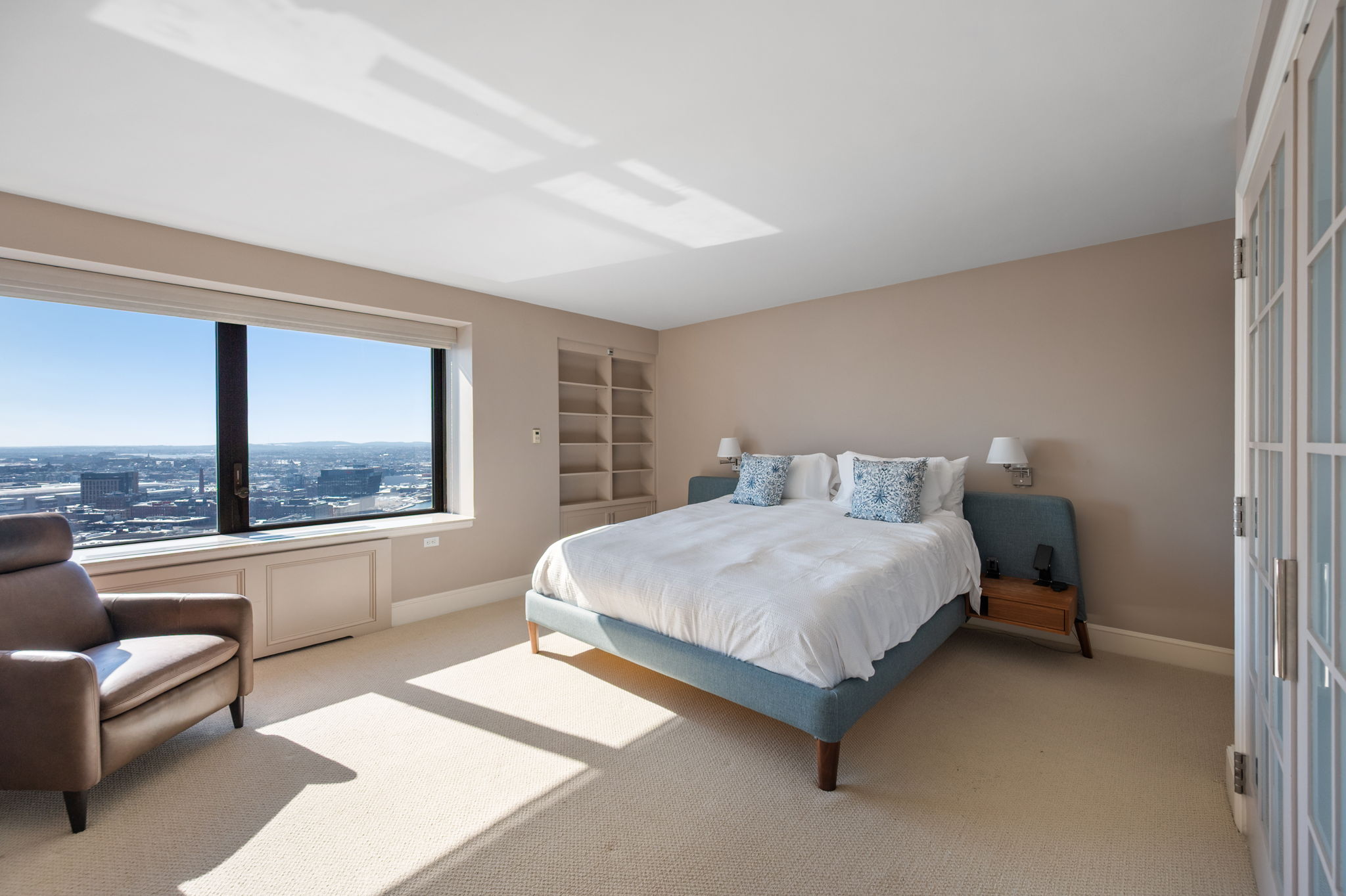 65 East India Row, Unit 38 F/G Boston, MA 02110 - Photo 15 of 32 a bedroom with a bed lamp on desk and a large window