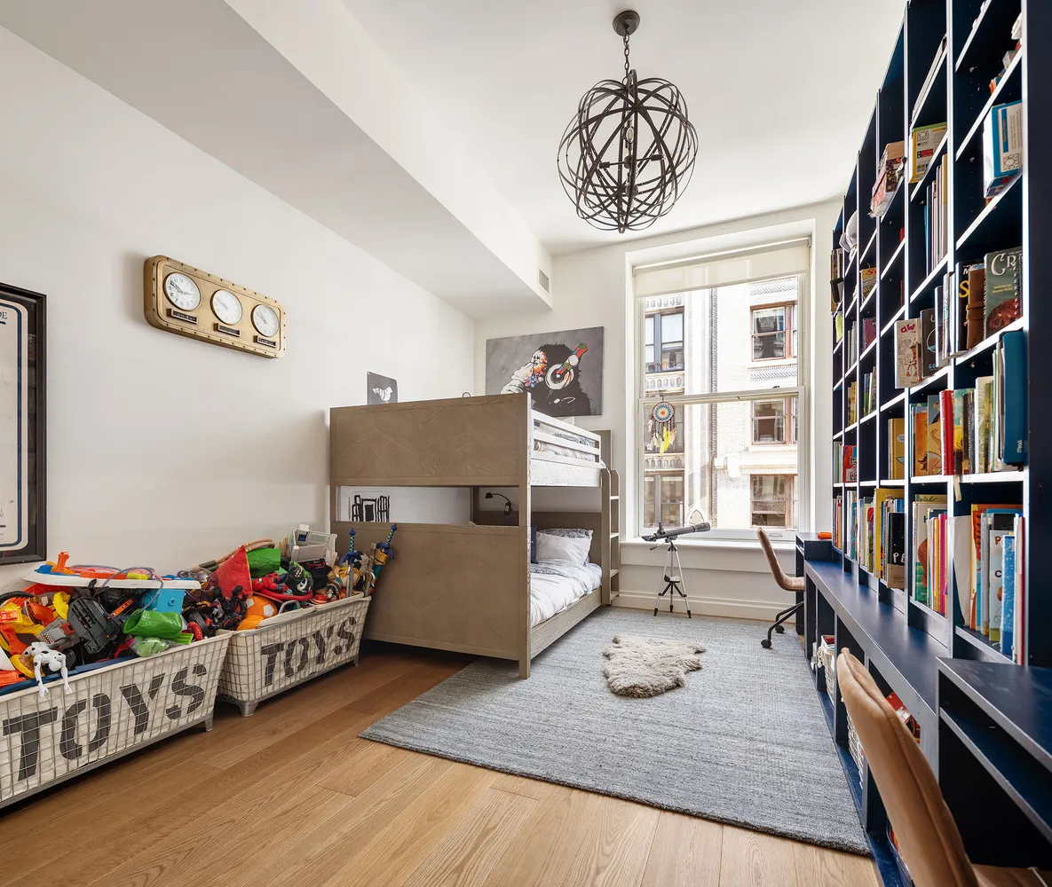 a bedroom with furniture and a book shelf