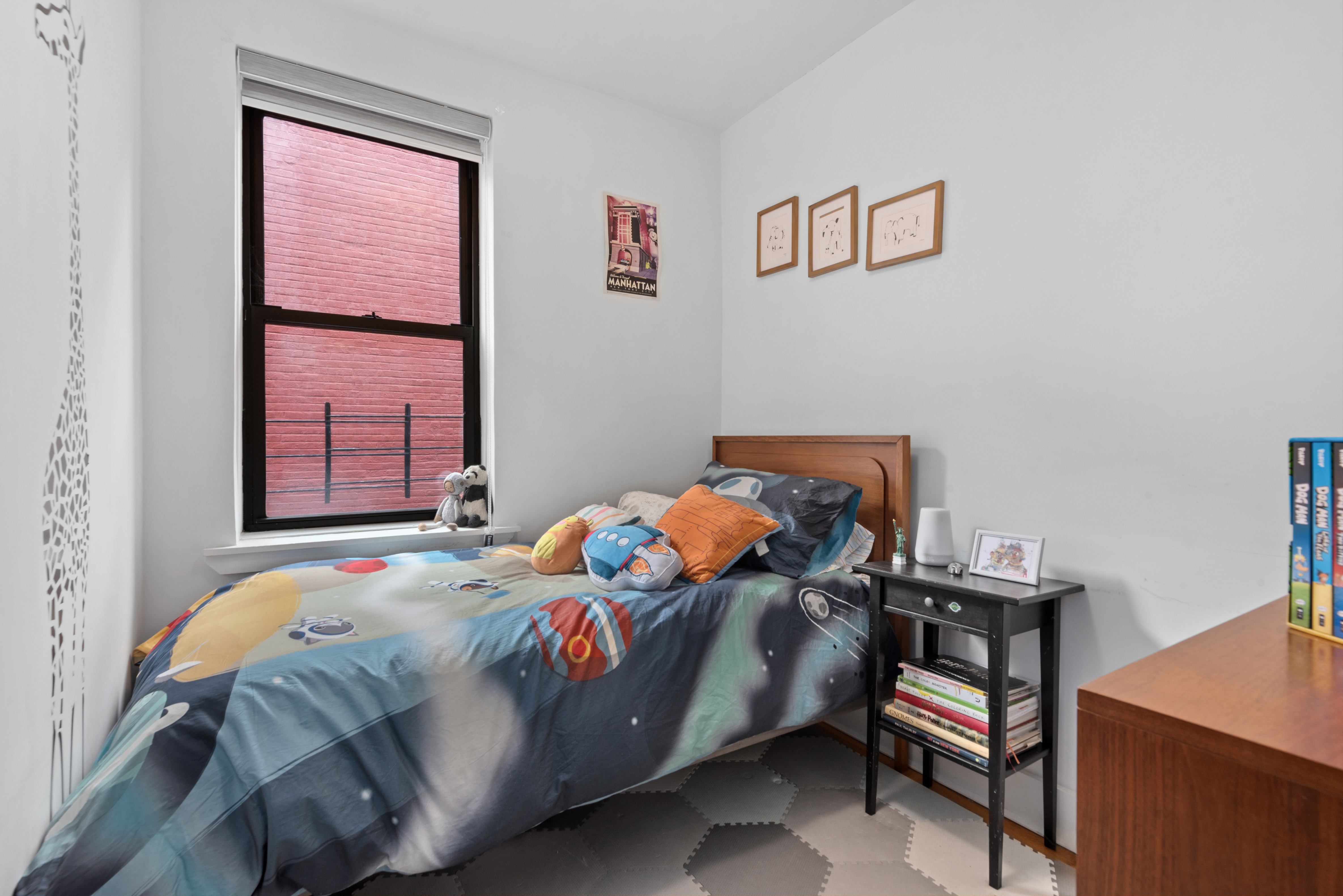 50-54 East 8th Street, Unit 5S Manhattan, NY 10003 - Photo 5 of 8 a bedroom with a bed and a window