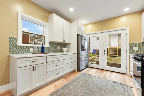 a kitchen with a table chairs stove and cabinets
