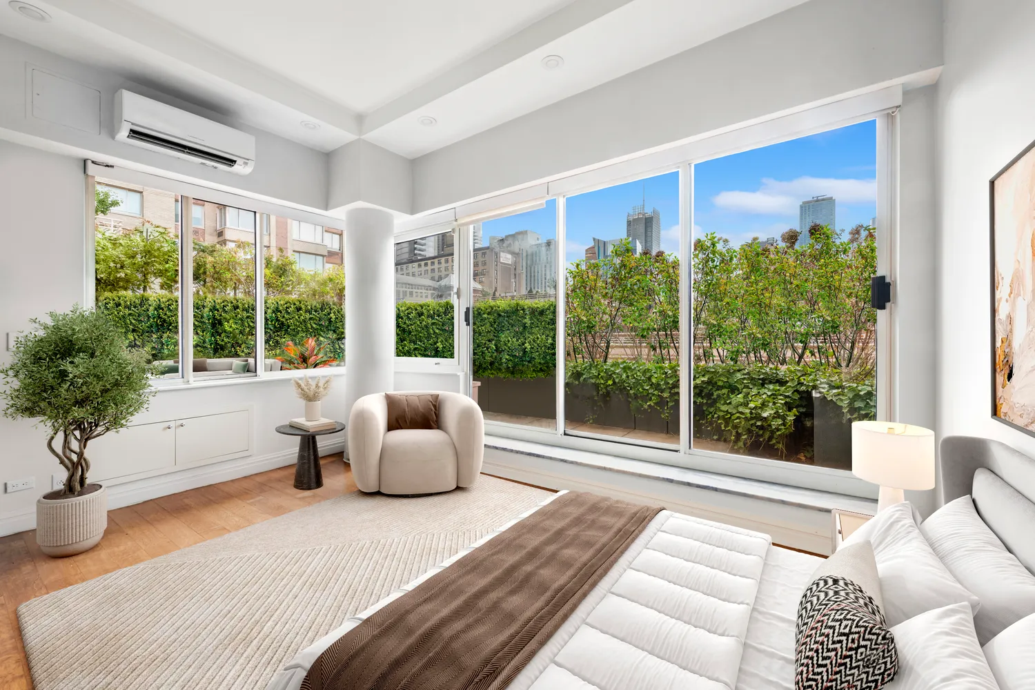 a bedroom with furniture and a large window