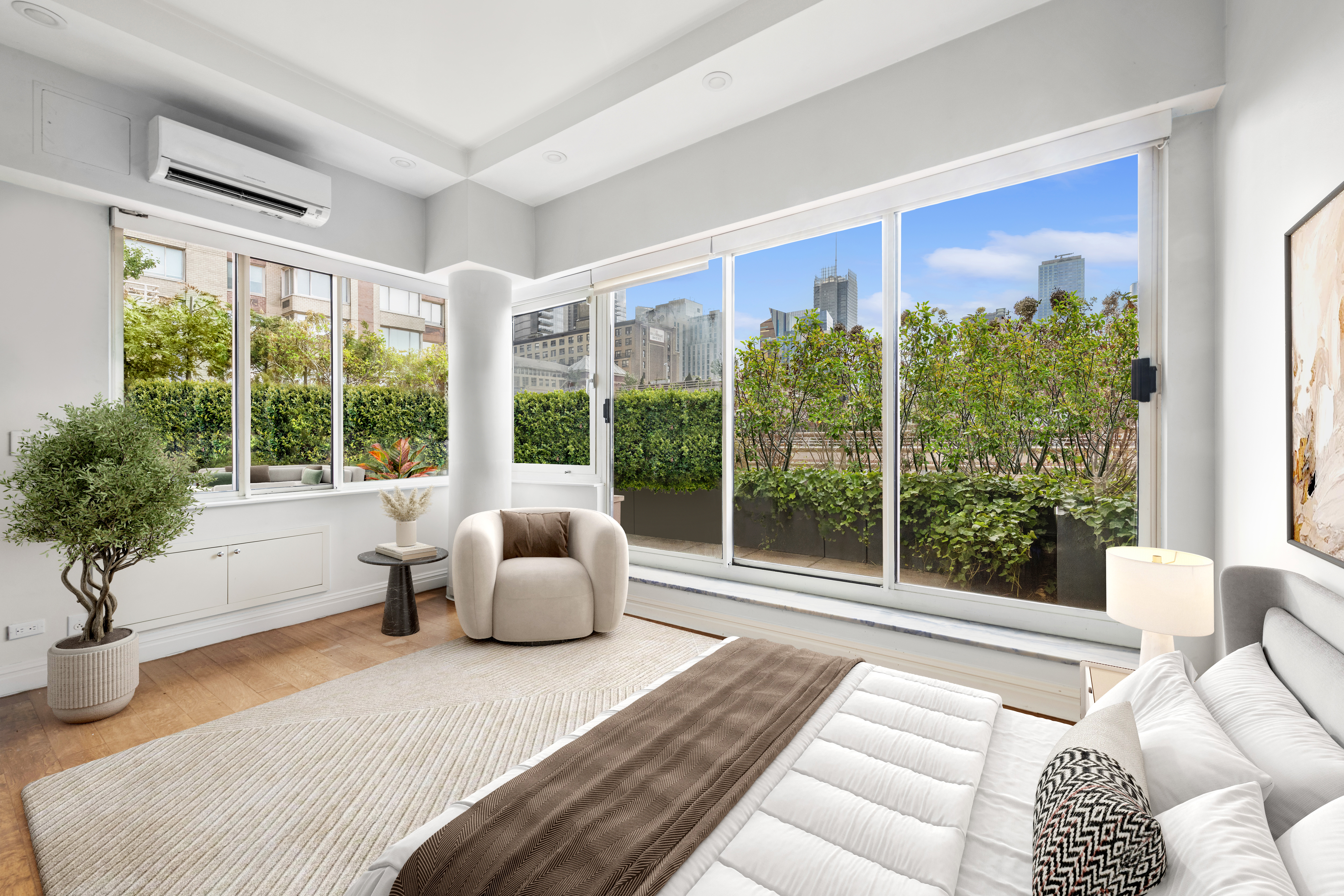 393 West 49th Street, Unit 5NN Manhattan, NY 10019 - Photo 7 of 13 a bedroom with furniture and a large window