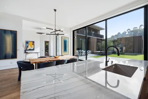 a living room with a large window and furniture