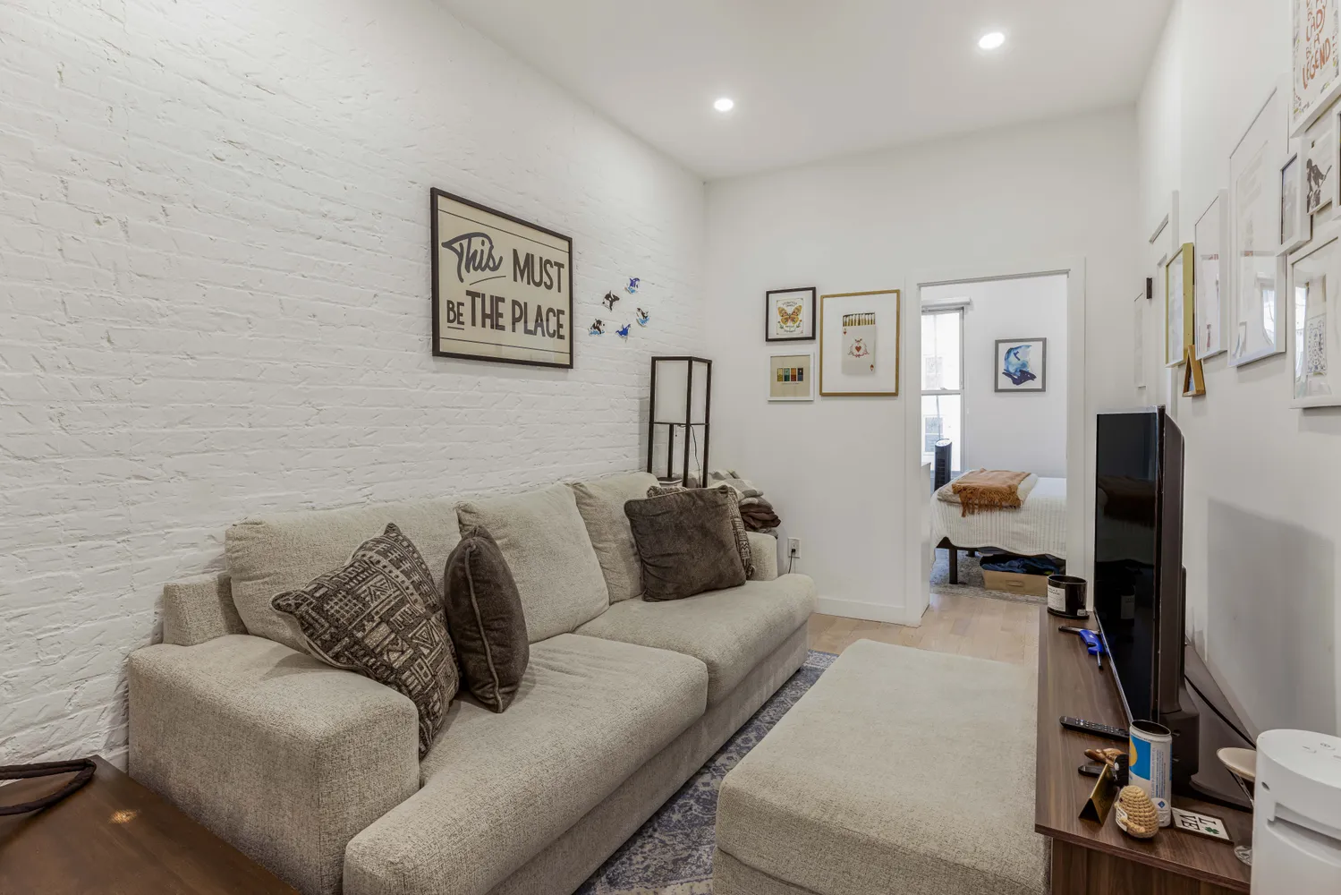 a living room with furniture and a flat screen tv
