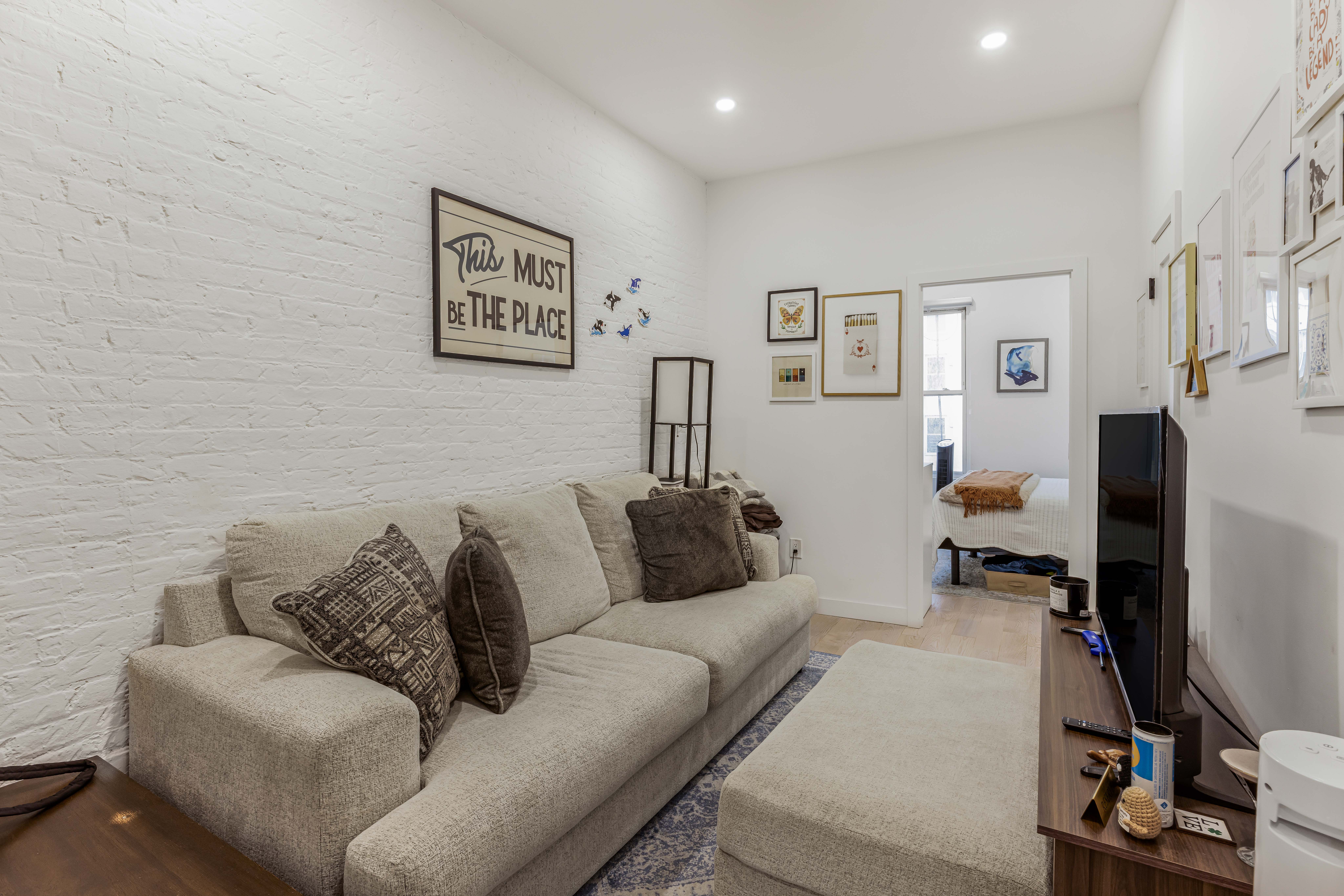 a living room with furniture and a flat screen tv