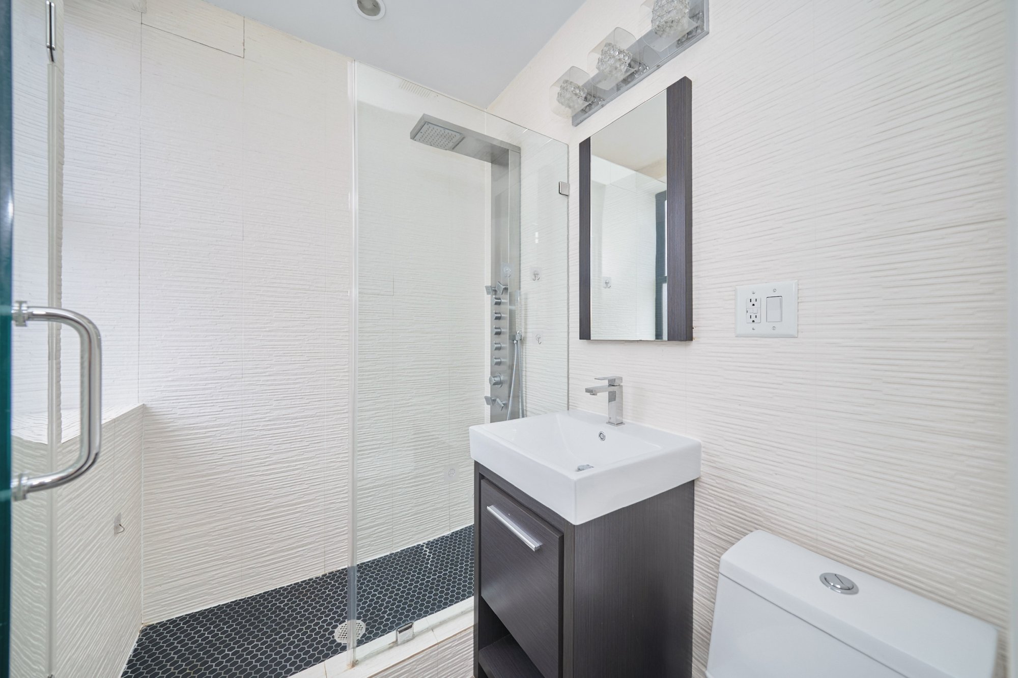20 Avenue A, Unit 5E Manhattan, NY 10009 - Photo 5 of 8 a bathroom with a sink and a mirror