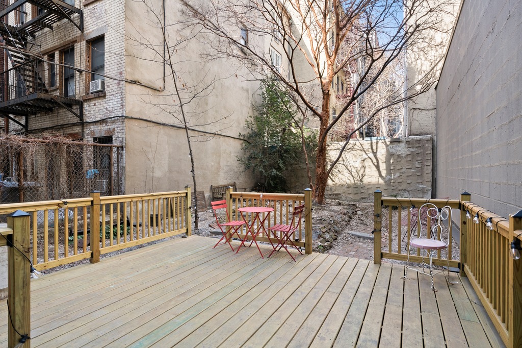 151 1st Avenue, Unit 3F Manhattan, NY 10003 - Photo 8 of 9 a deck view with two chairs and wooden floor