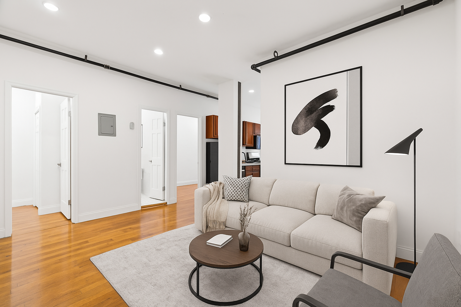 a living room with furniture and a wooden floor