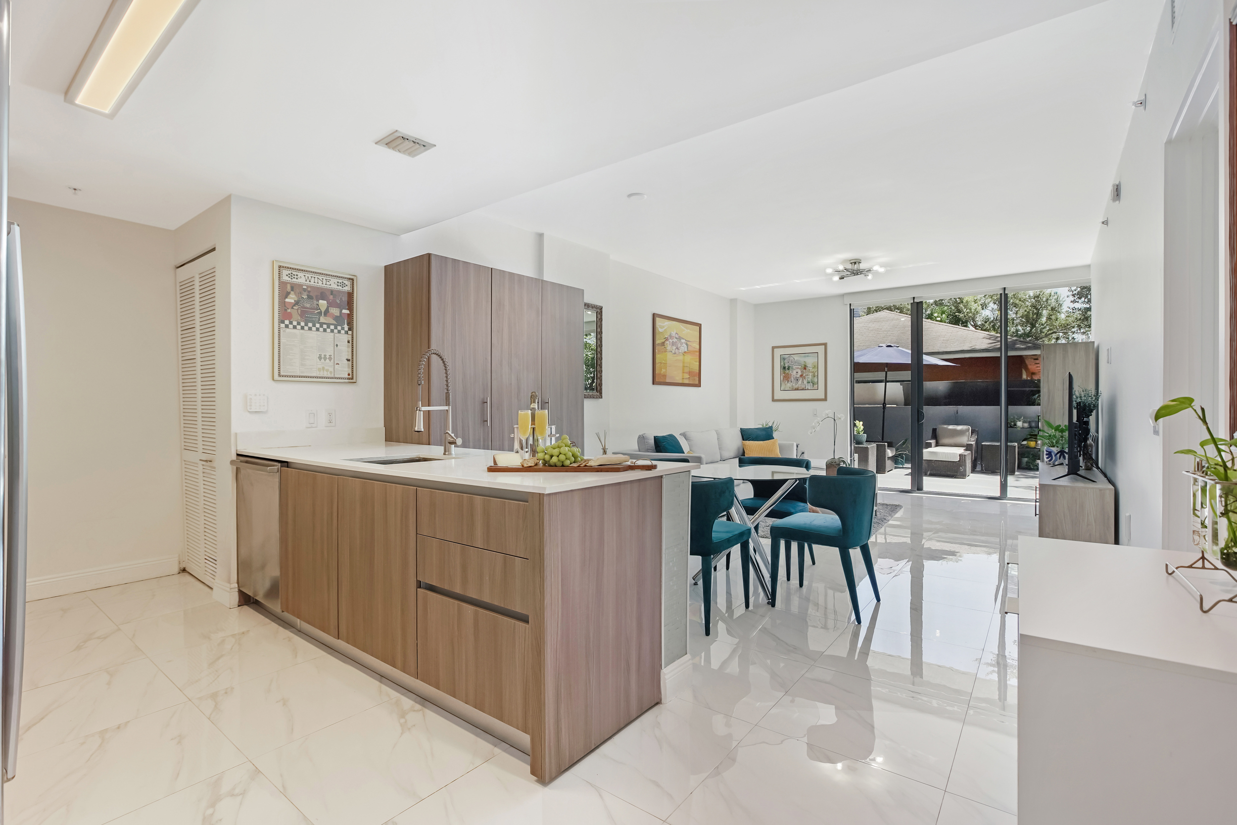 201 Southwest 17th Road, Unit 311 Miami, FL 33129 - Photo 4 of 21 a dining hall with stainless steel appliances kitchen island granite countertop a table and chairs in it