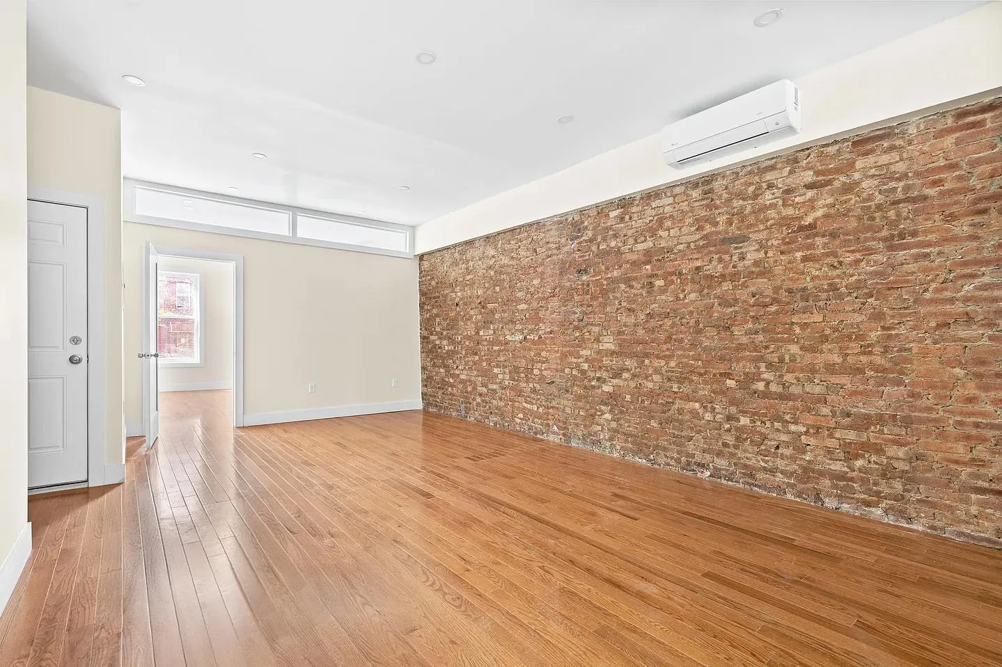 a view of an empty room and wooden floor