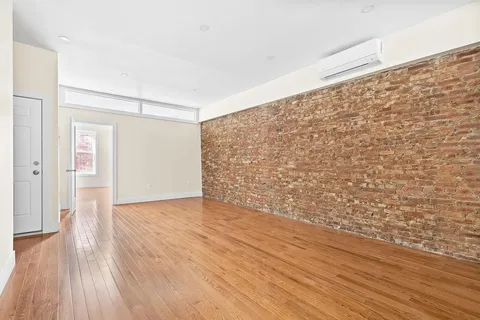 a view of an empty room and wooden floor