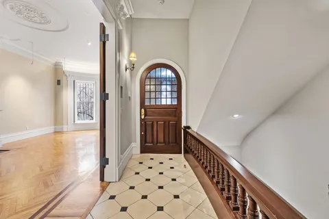 a view of a hallway view with wooden floor and staircase