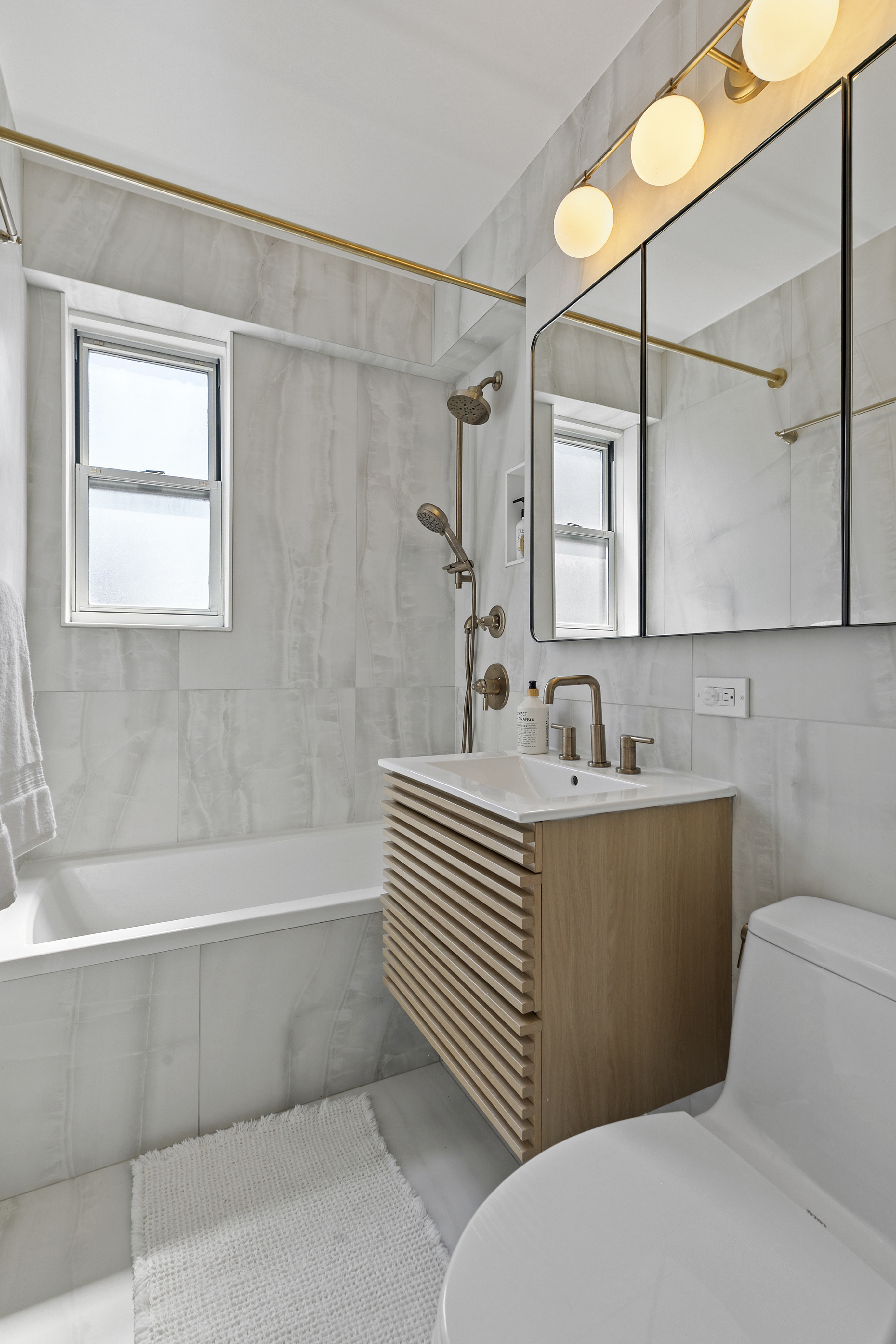 300 East 71st Street, Unit 17DEF Manhattan, NY 10021 - Photo 9 of 16 a bathroom with a sink a toilet and shower