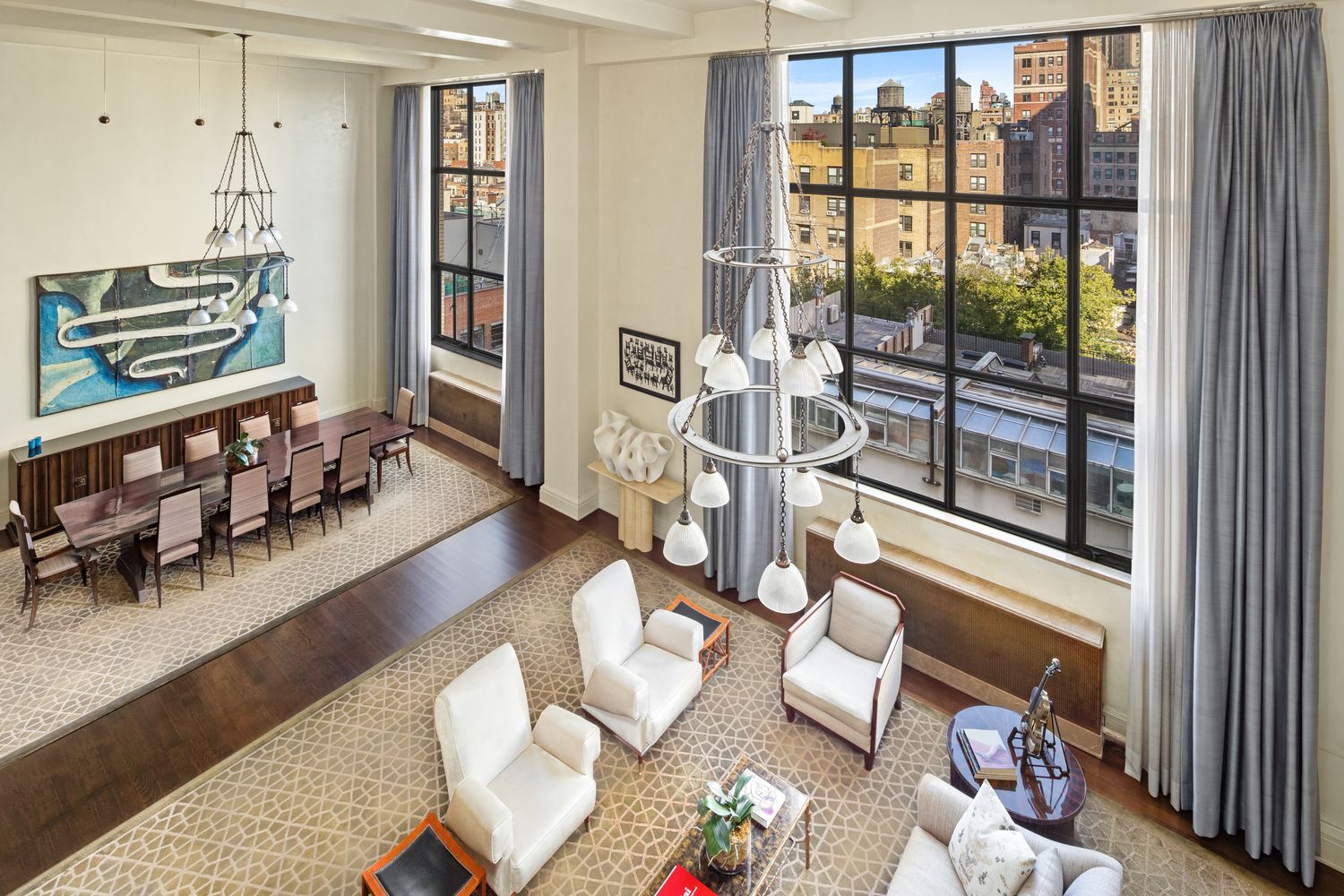 a living room with furniture a flat screen tv and a floor to ceiling window