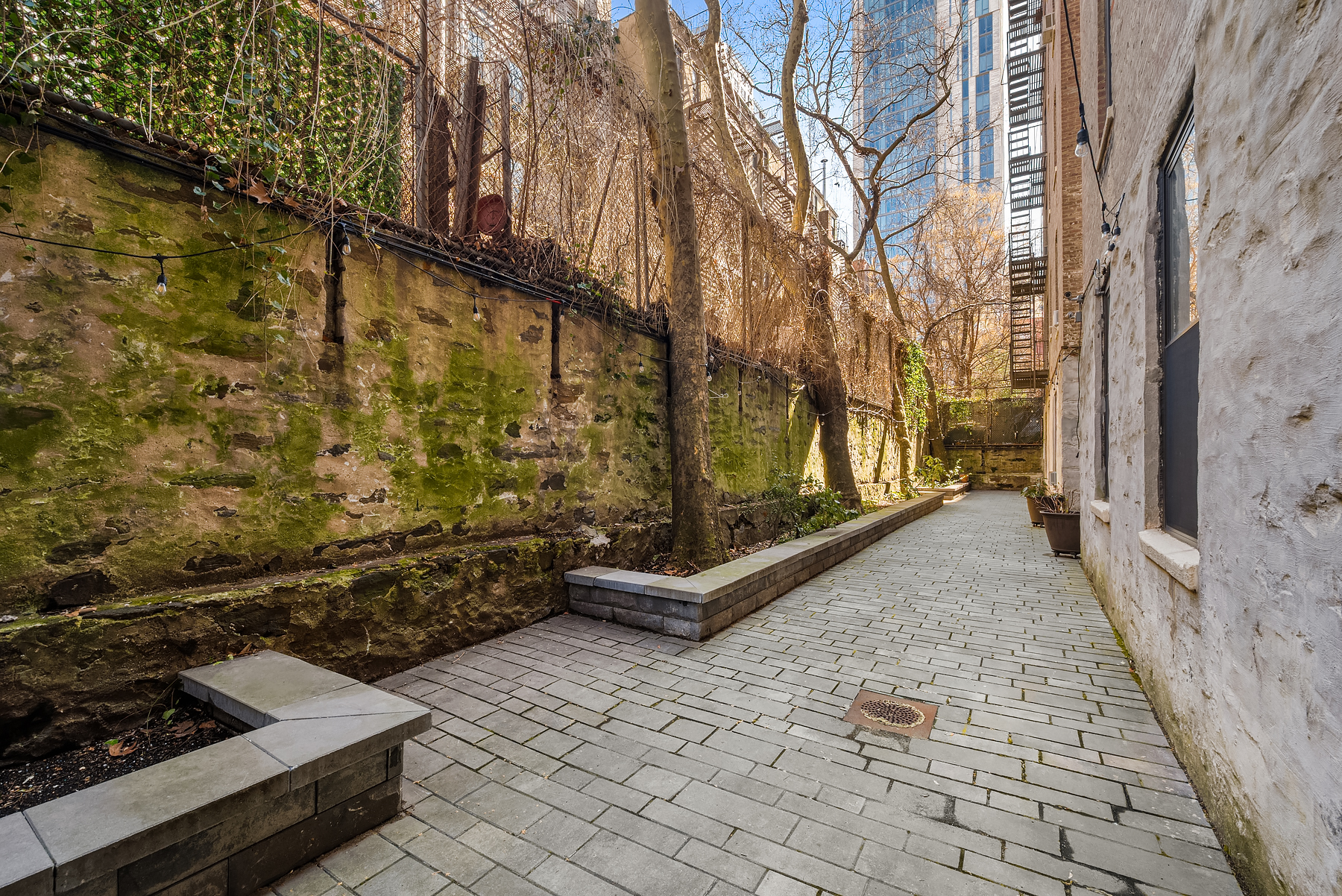 305 East 88th Street, Unit 3E Manhattan, NY 10128 - Photo 6 of 9 a bench is sitting in front of a brick house