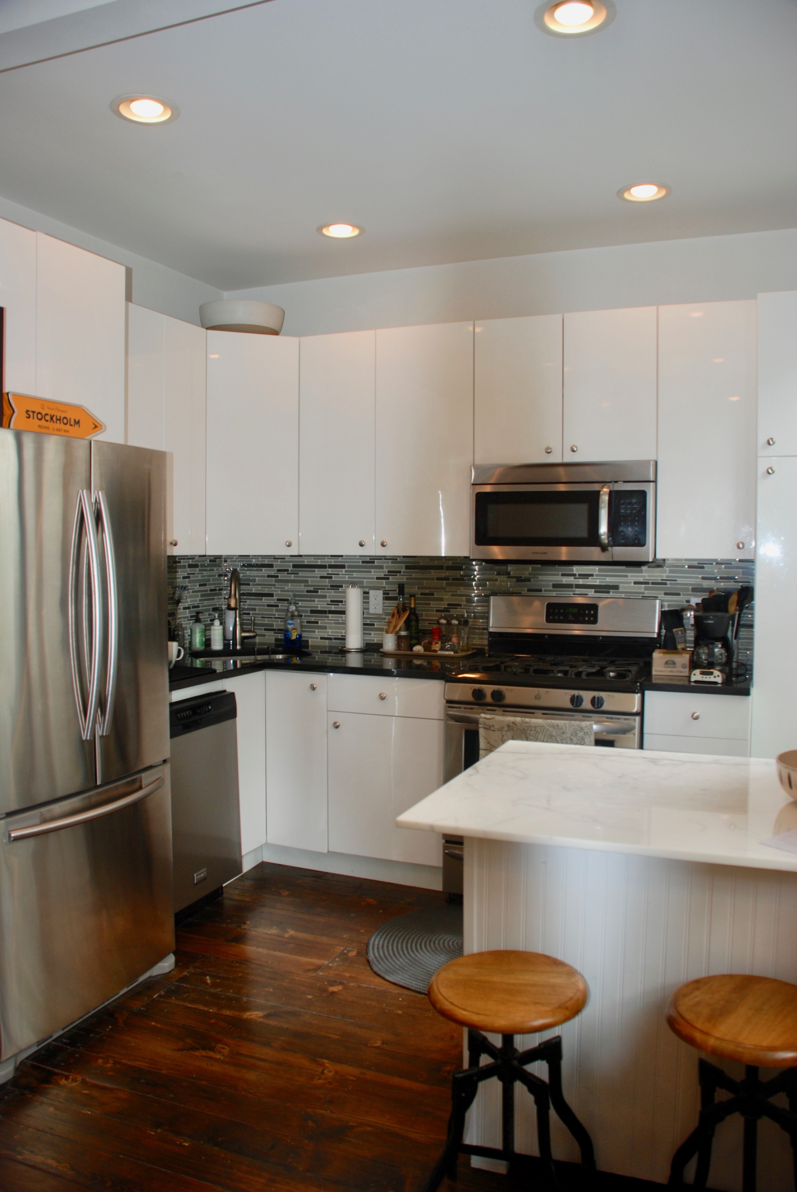 511 Clinton Street, Unit 3 Brooklyn, NY 11231 - Photo 4 of 12 a kitchen with stainless steel appliances wooden floor and a refrigerator