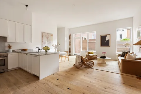 a living room with furniture and large windows