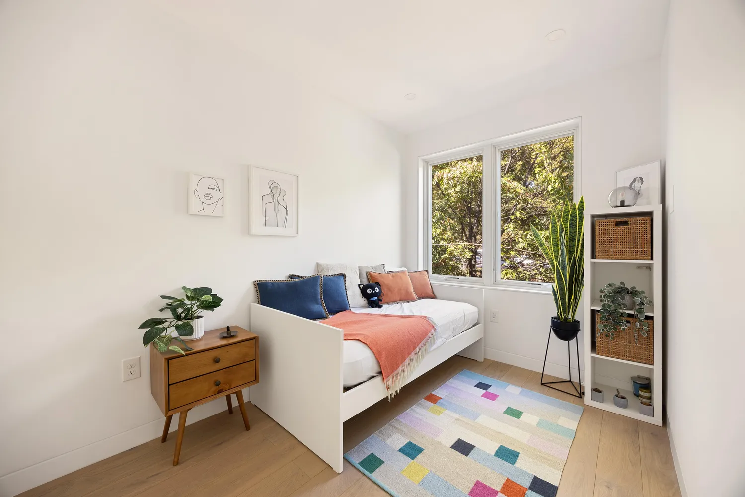 a room with a bed and a potted plant
