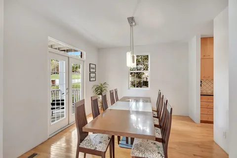 a kitchen with counter top space and dining table