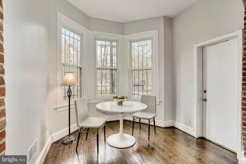 a view of a dining room with furniture window and wooden floor