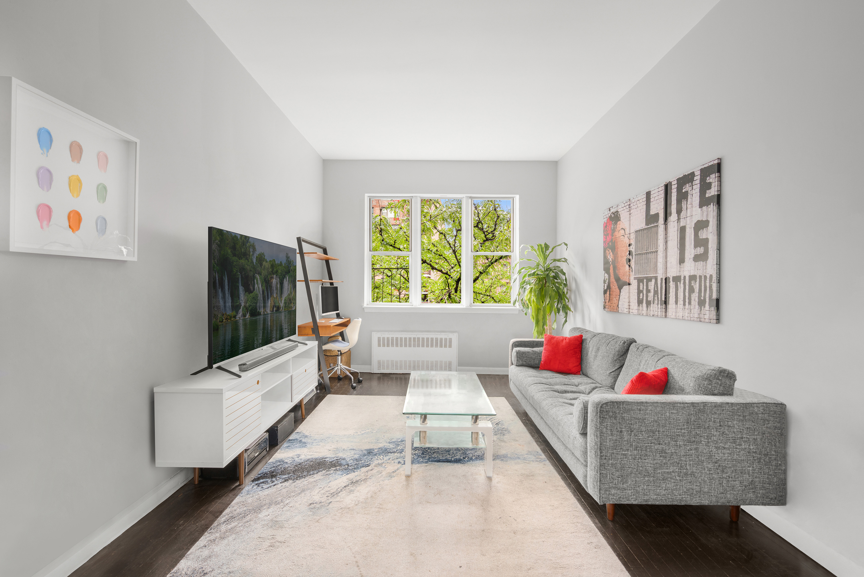 a living room with furniture and a flat screen tv