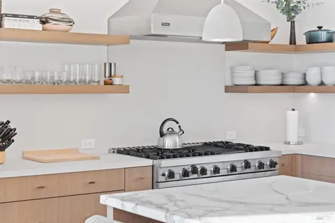 a kitchen with a stove and cabinets