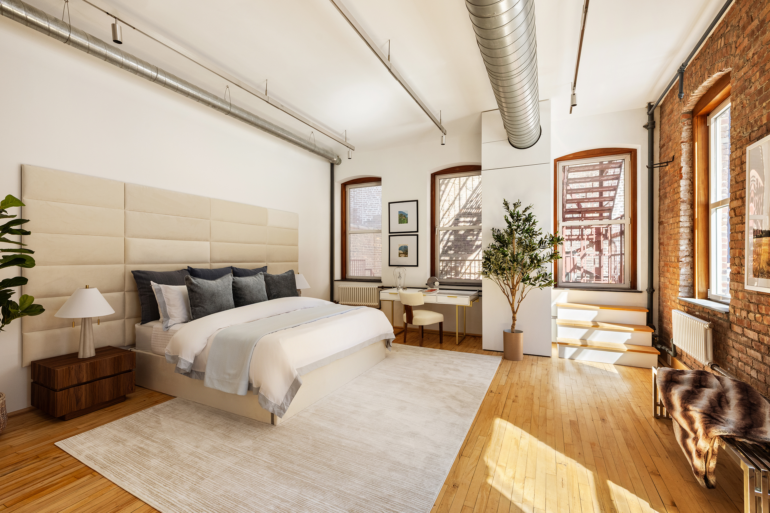 25 East 4th Street, Unit 2 Manhattan, NY 10003 - Photo 5 of 12 a bedroom with a large bed and a chandelier