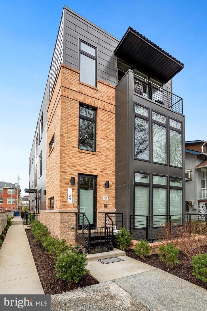 129 Varnum Street Northwest, Unit 6 Washington, DC 20011 - Photo 2 of 25 a front view of a building with a garden