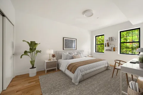 a bedroom with a bed and a window