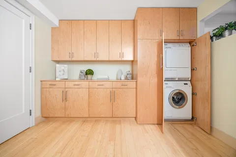 a view of a storage and utility room with washer and dryer