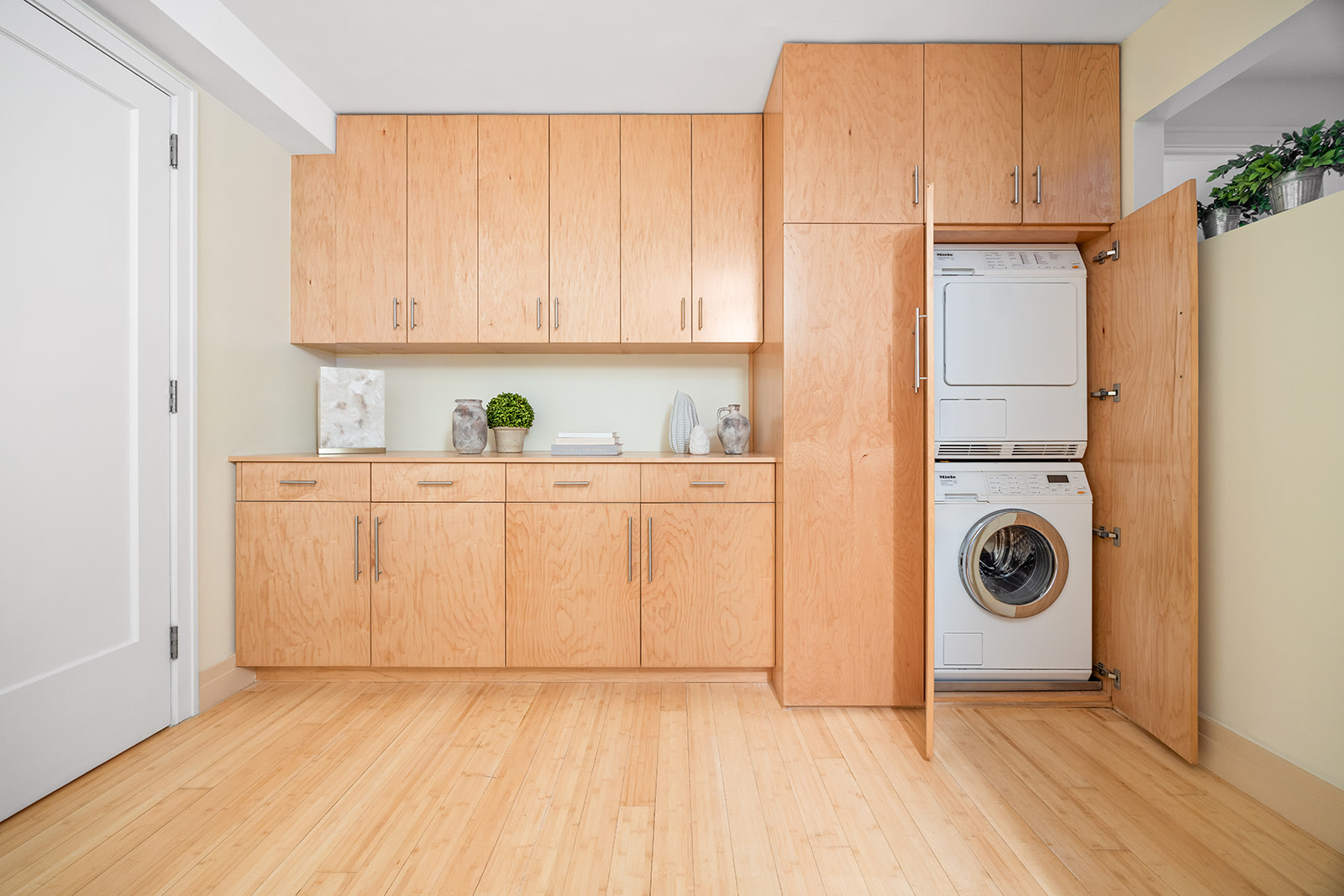 208 East Broadway, Unit J405/J406 Manhattan, NY 10002 - Photo 14 of 21 a view of a storage and utility room with washer and dryer