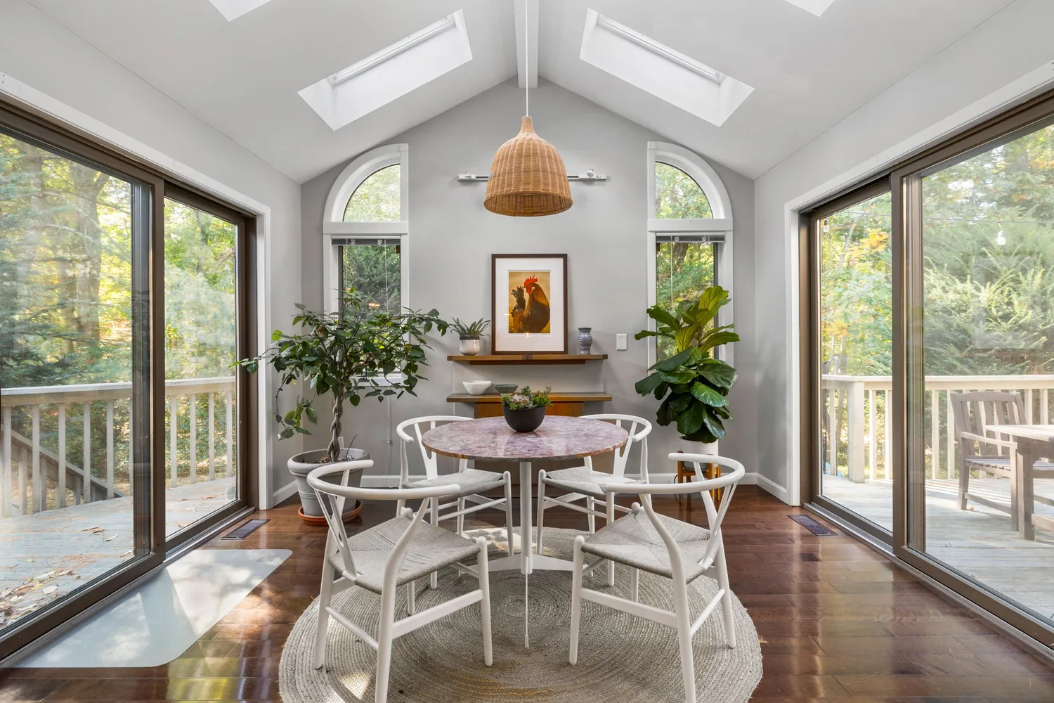 a view of a dining room with furniture large windows and wooden floor