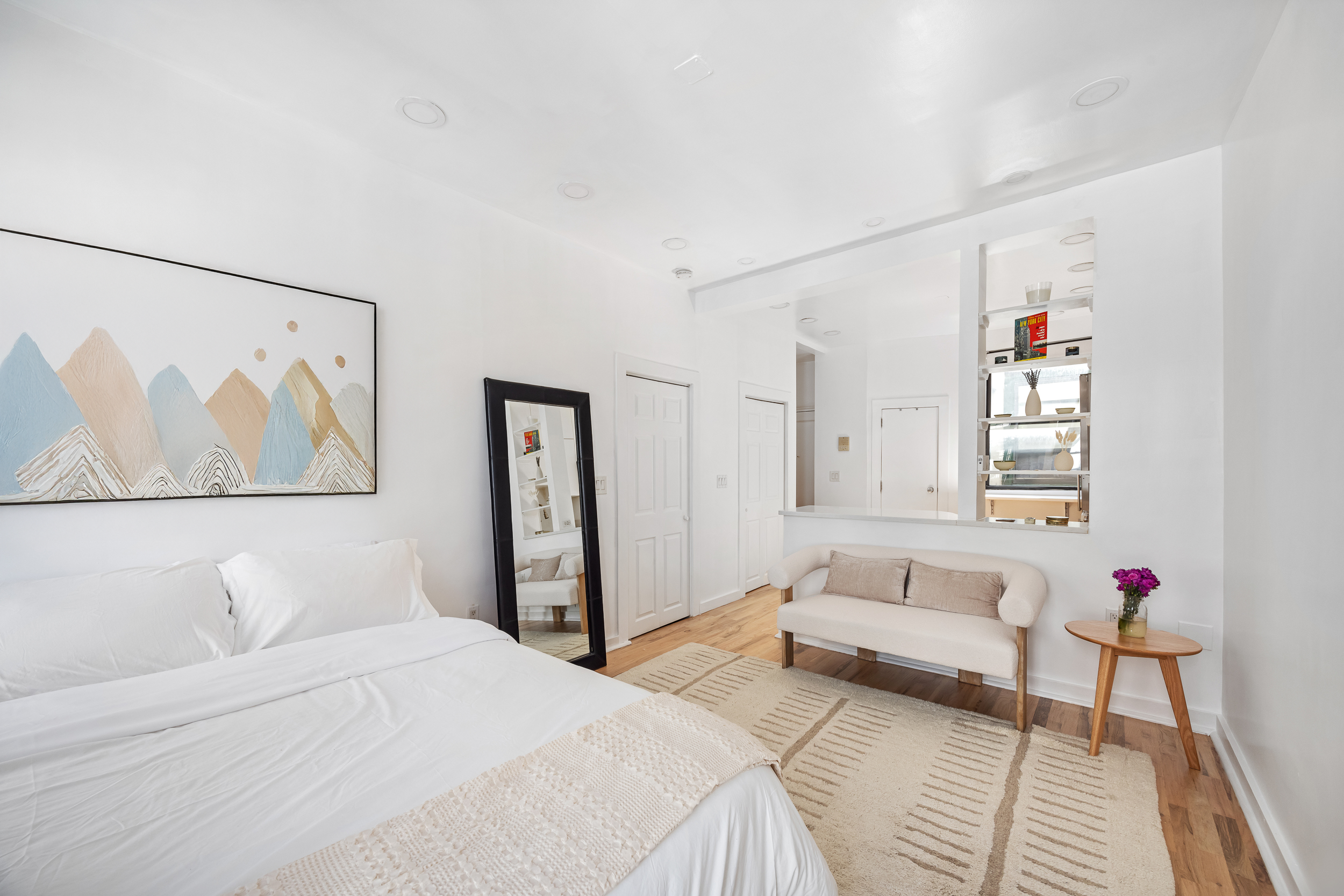 13 Downing Street, Unit 9 Manhattan, NY 10014 - Photo 3 of 8 a spacious bedroom with a bed and a couch