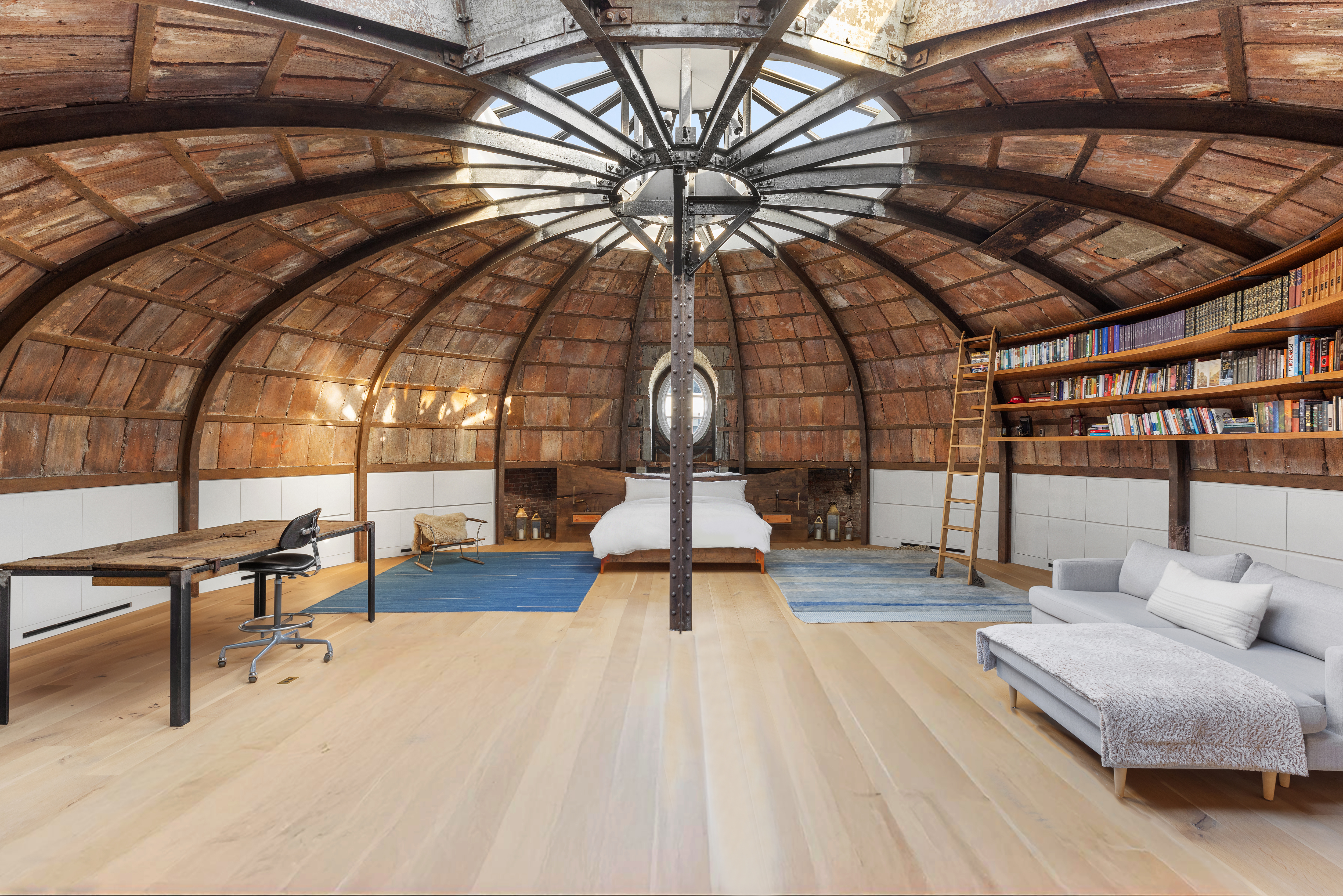 a living room with couch and wooden floor
