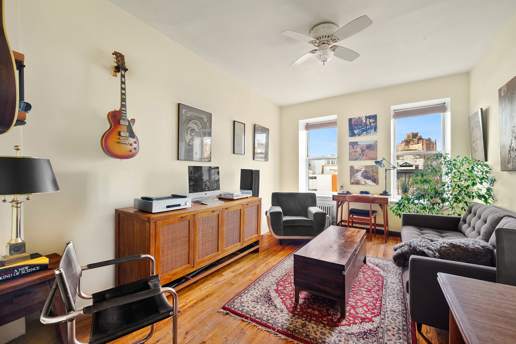 88 Charles Street, Unit 5D Manhattan, NY 10014 - Photo 2 of 11 a living room with furniture gym equipment and a flat screen tv