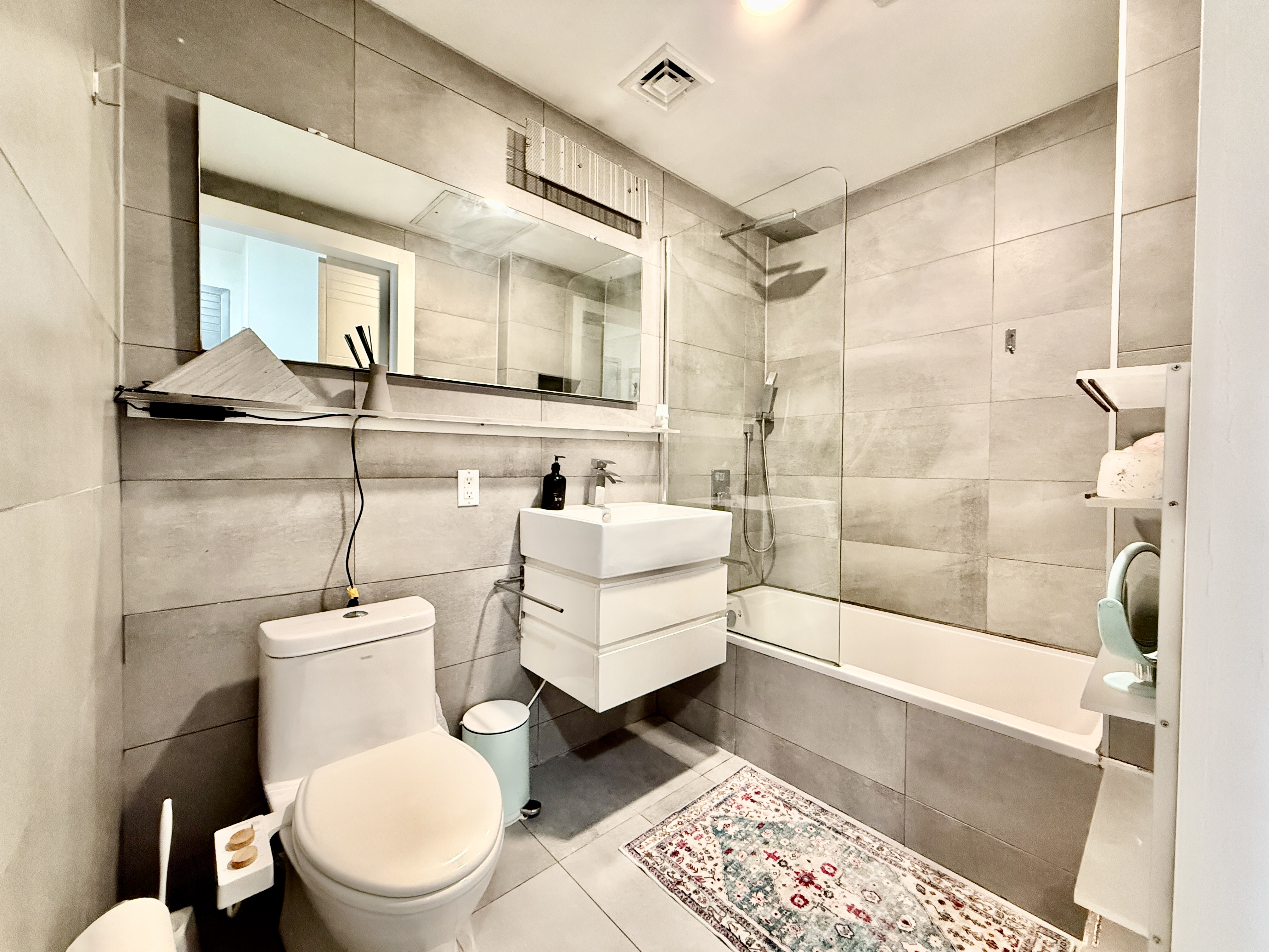 668 Halsey Street, Unit 1 Brooklyn, NY 11233 - Photo 7 of 14 a bathroom with a toilet a sink and a bathtub