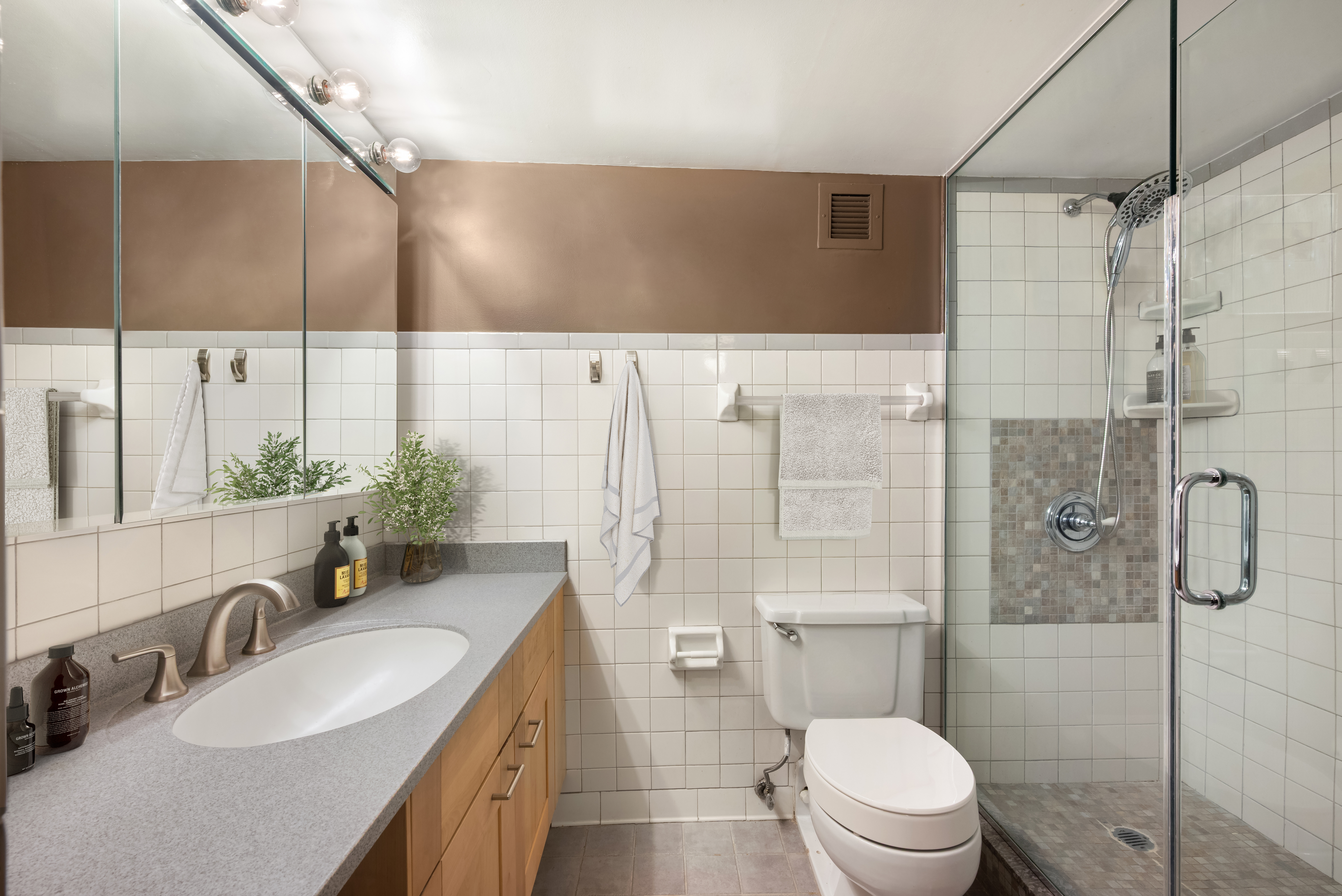 421 Hudson Street, Unit 213 Manhattan, NY 10014 - Photo 5 of 7 a bathroom with a sink toilet vanity and shower