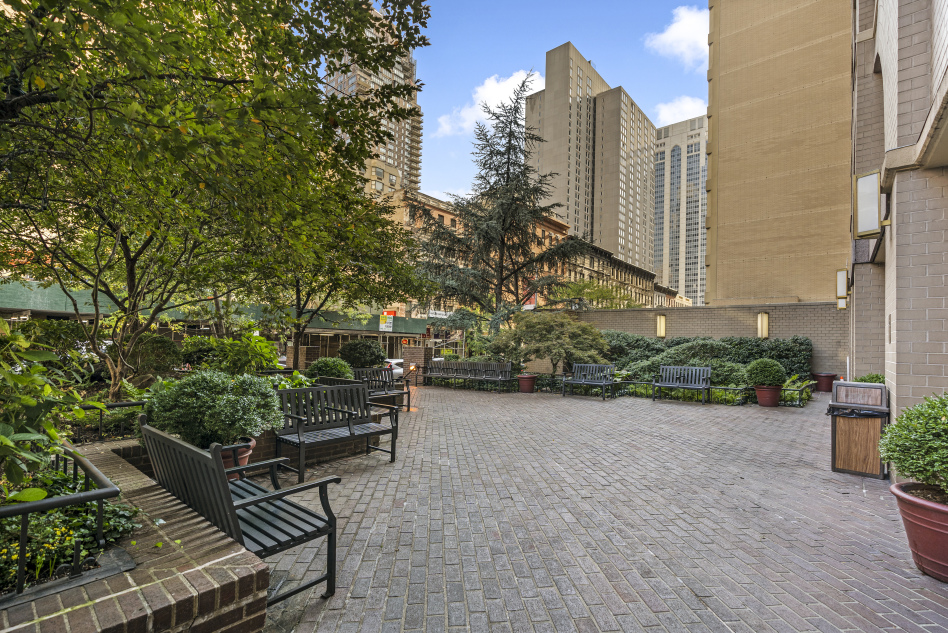 400 East 70th Street, Unit 3301 Manhattan, NY 10021 - Photo 17 of 20 a bench sitting in front of a building