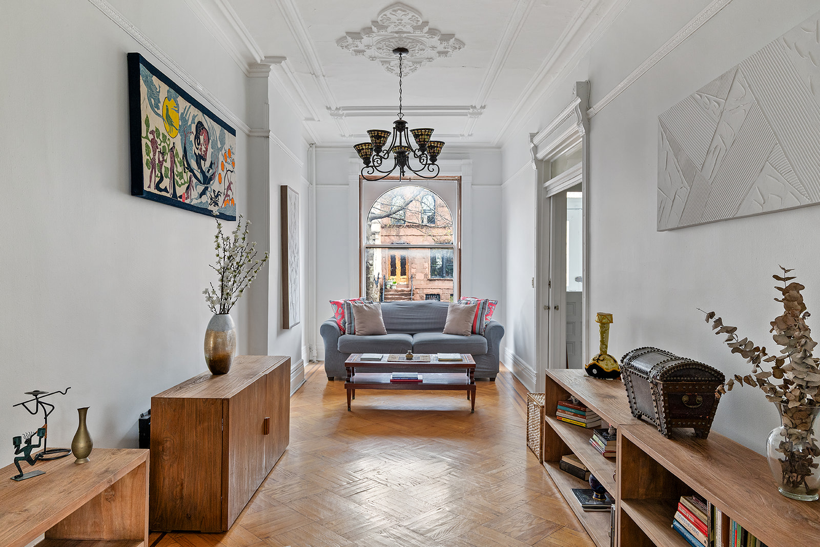 156 Bainbridge Street Brooklyn, NY 11233 - Photo 1 of 14 a living room with furniture and a chandelier