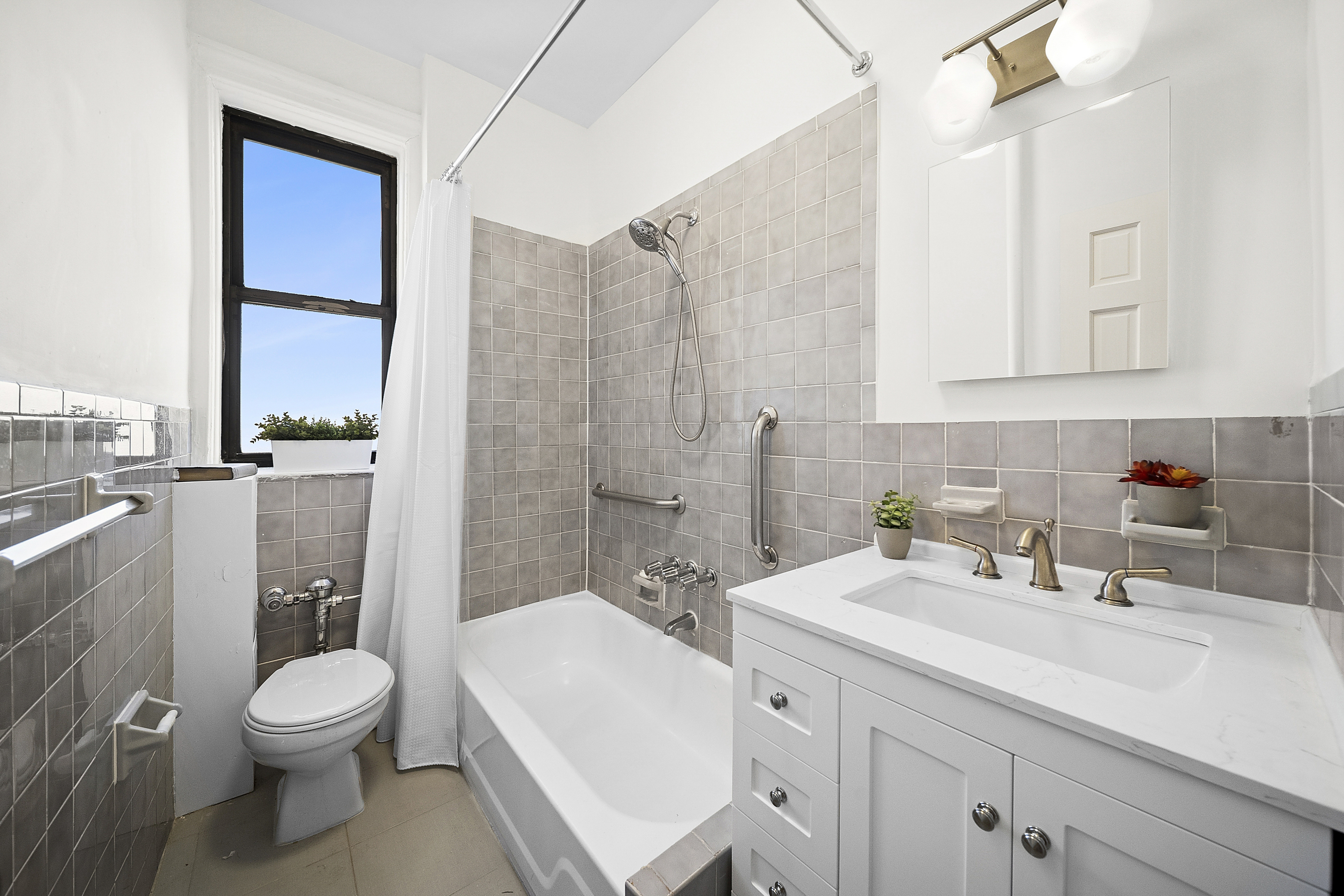 7401 4th Avenue, Unit F8 Brooklyn, NY 11209 - Photo 3 of 5 a bathroom with a sink a toilet and shower