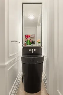 a room with a sink and a mirror