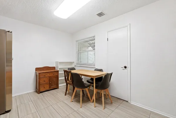 a kitchen with a table chairs sink and cabinets