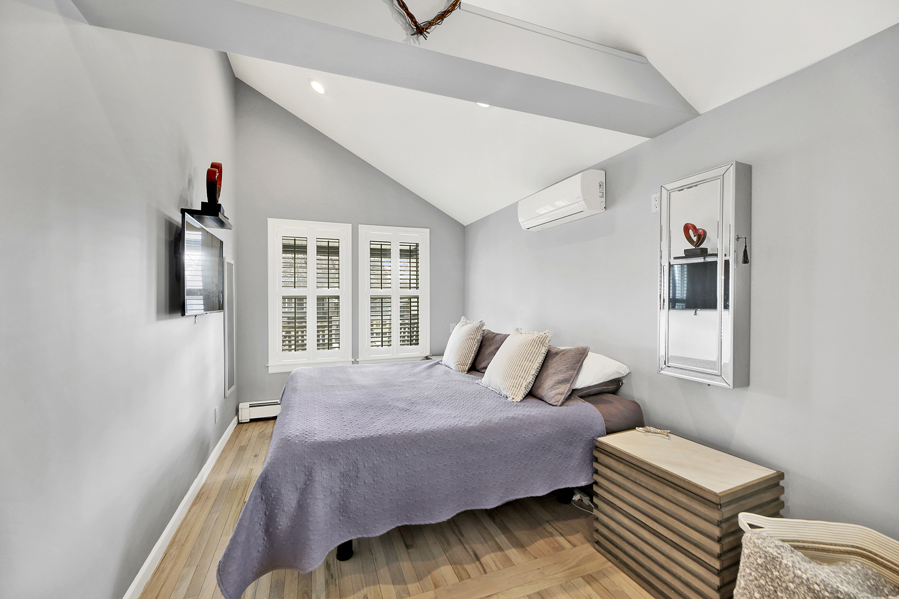 4-53 Beach 142nd Street Queens, NY 11694 - Photo 21 of 39 a bedroom with a bed and wooden floor